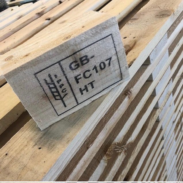 Close-up of an IPPC mark with GB FC107 and HT on a pallet block
