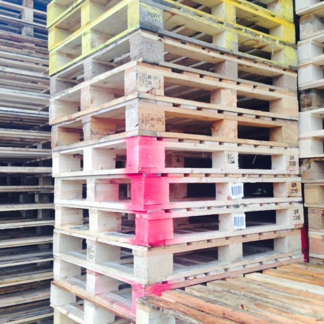 Mixed wooden pallets with pink and yellow painted edges